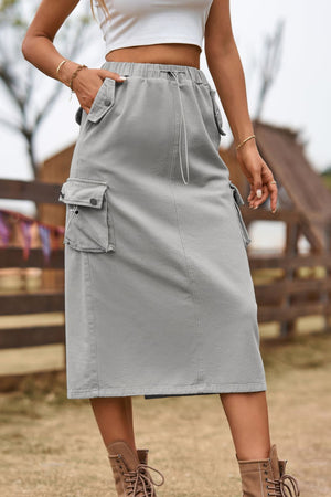 Mid gray utility pocket midi skirt with drawstring waist and button flap pockets.