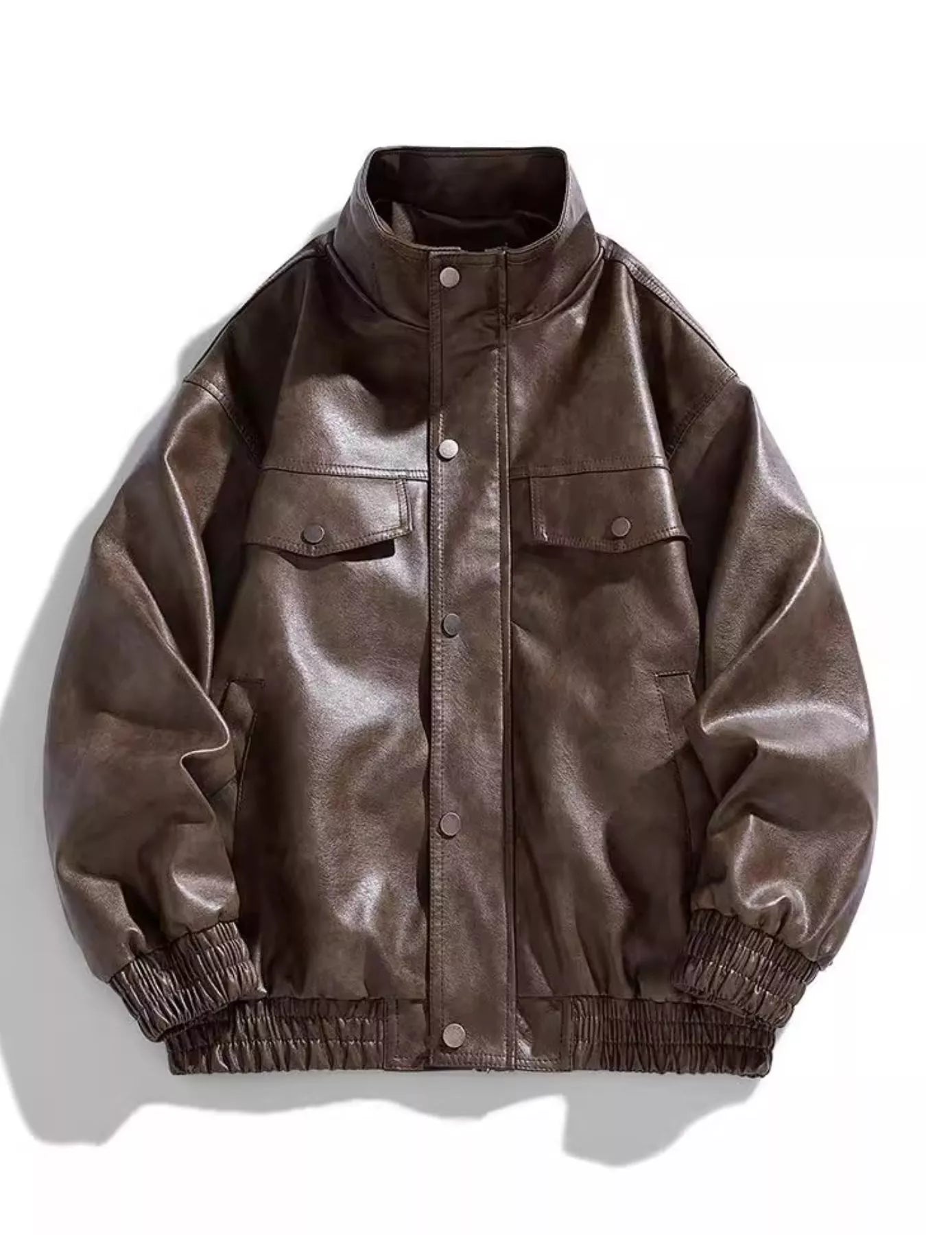 Oversized coffee faux leather bomber jacket with snap down front and chest pockets.