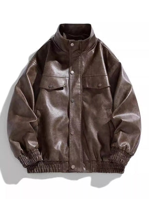 Oversized coffee faux leather bomber jacket with snap down front and chest pockets.