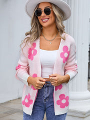 Blush pink acrylic intarsia knit cardigan with large pink floral pattern and white cuffs.