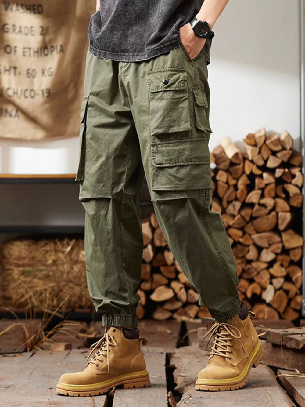 Military green cargo pants with multiple pockets and elastic cuffs.