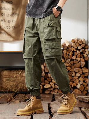 Military green cargo pants with multiple pockets and elastic cuffs.