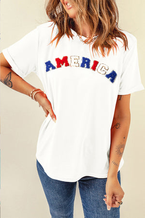 White t-shirt with embroidered "America" text and rolled sleeves