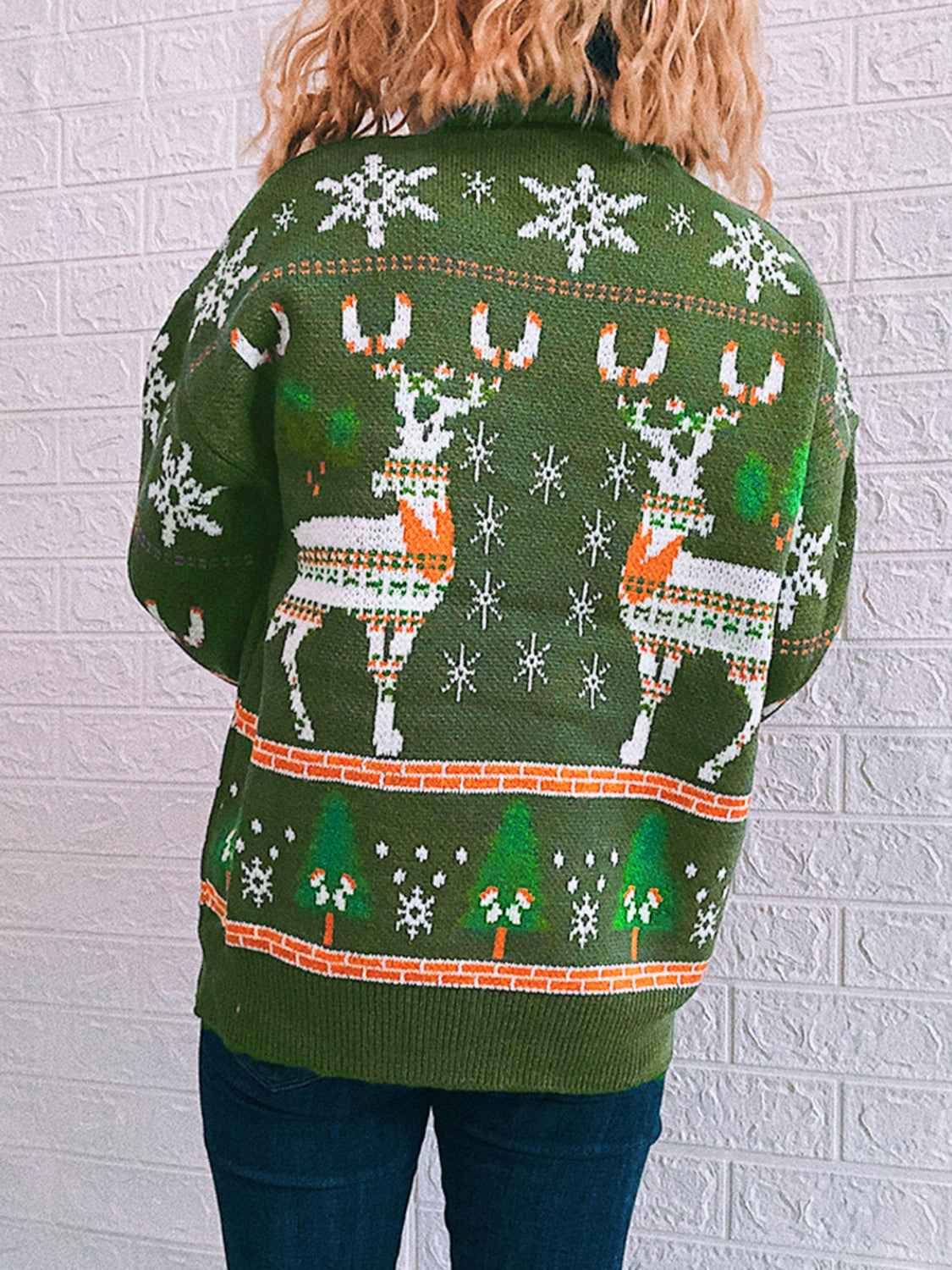 Green acrylic turtleneck sweater with intarsia reindeer, snowflakes, and trees pattern.