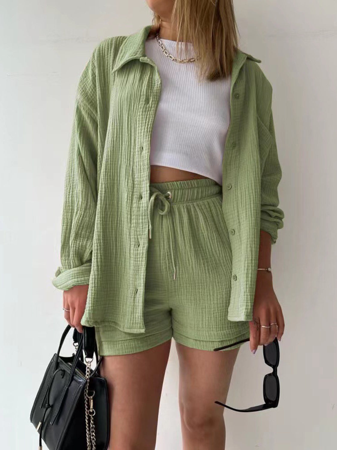 Sage green textured gauze shirt and shorts set with drawstring shorts and button-up shirt.