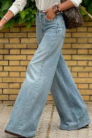 High-waisted palazzo flare denim jeans in medium wash, styled casually.