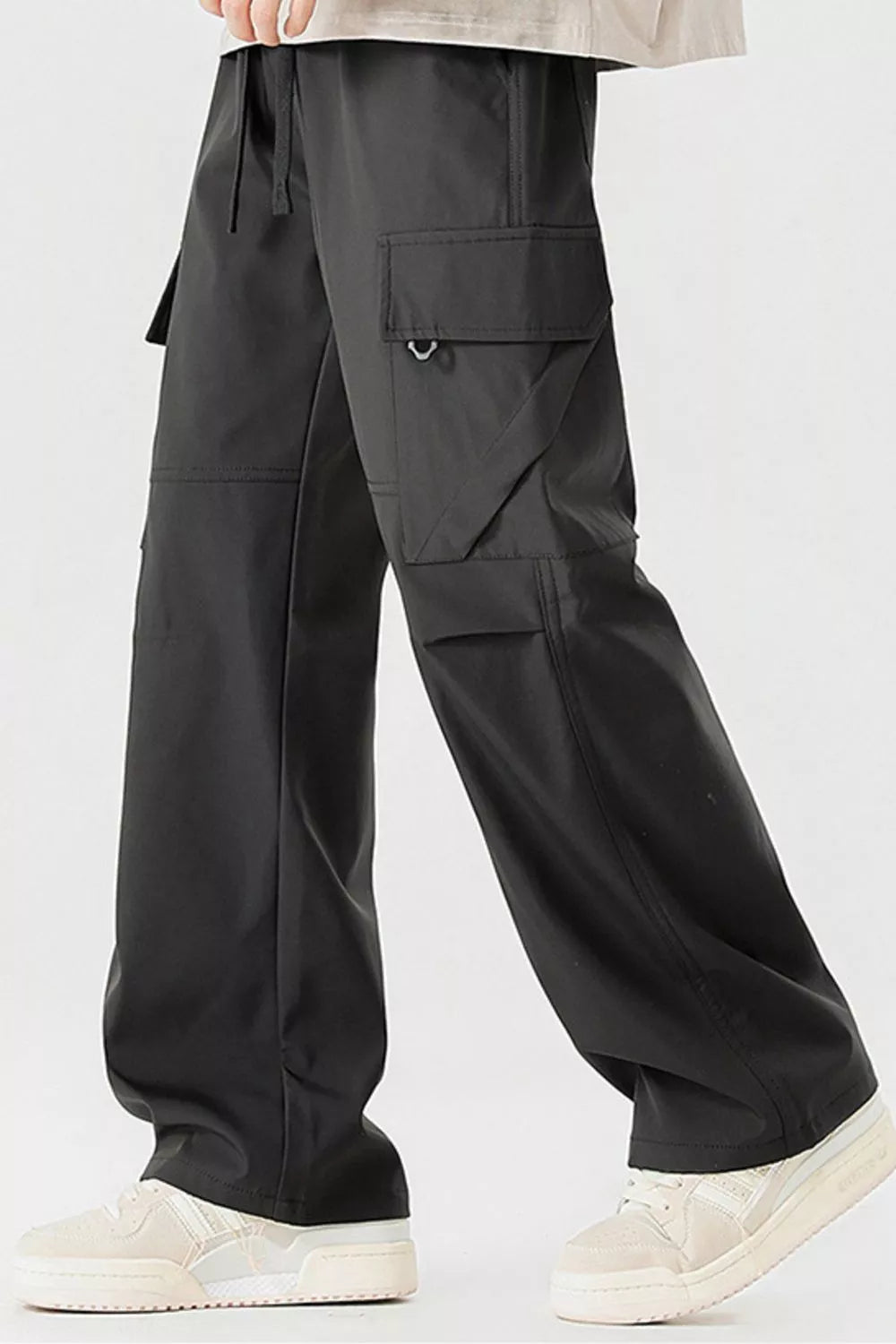 Black cargo pants with multiple pockets and a drawstring waist.