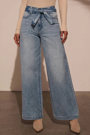 Belted wide-leg denim trousers in medium wash with a tie waist.