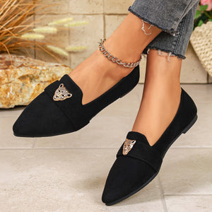 Black slip-on flats with pointed toe and leopard head embellishment