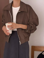 Brown zip-up jacket with collar, elastic cuffs, and buttoned flap pockets.