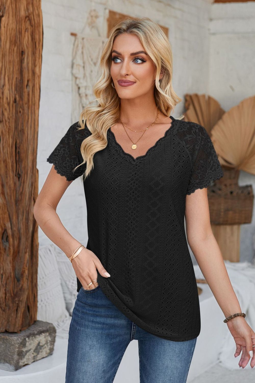 Black eyelet raglan blouse with lace short sleeves and scalloped neckline.