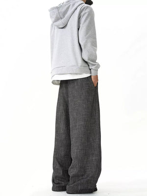 Men's charcoal wide leg sweatpants with textured fabric and ankle pooling detail.