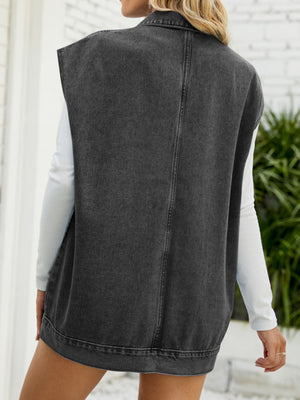 Dark denim utility vest with collared neck and oversized pockets, shown from the back.