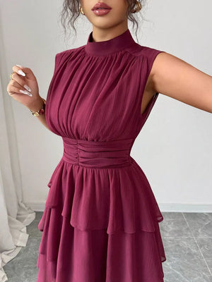 Dark Red sleeveless ruffle tiered dress with ruched bodice and mock neck.