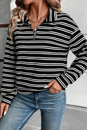 Black ribbed stripe half-zip pullover sweater with a collared neckline.