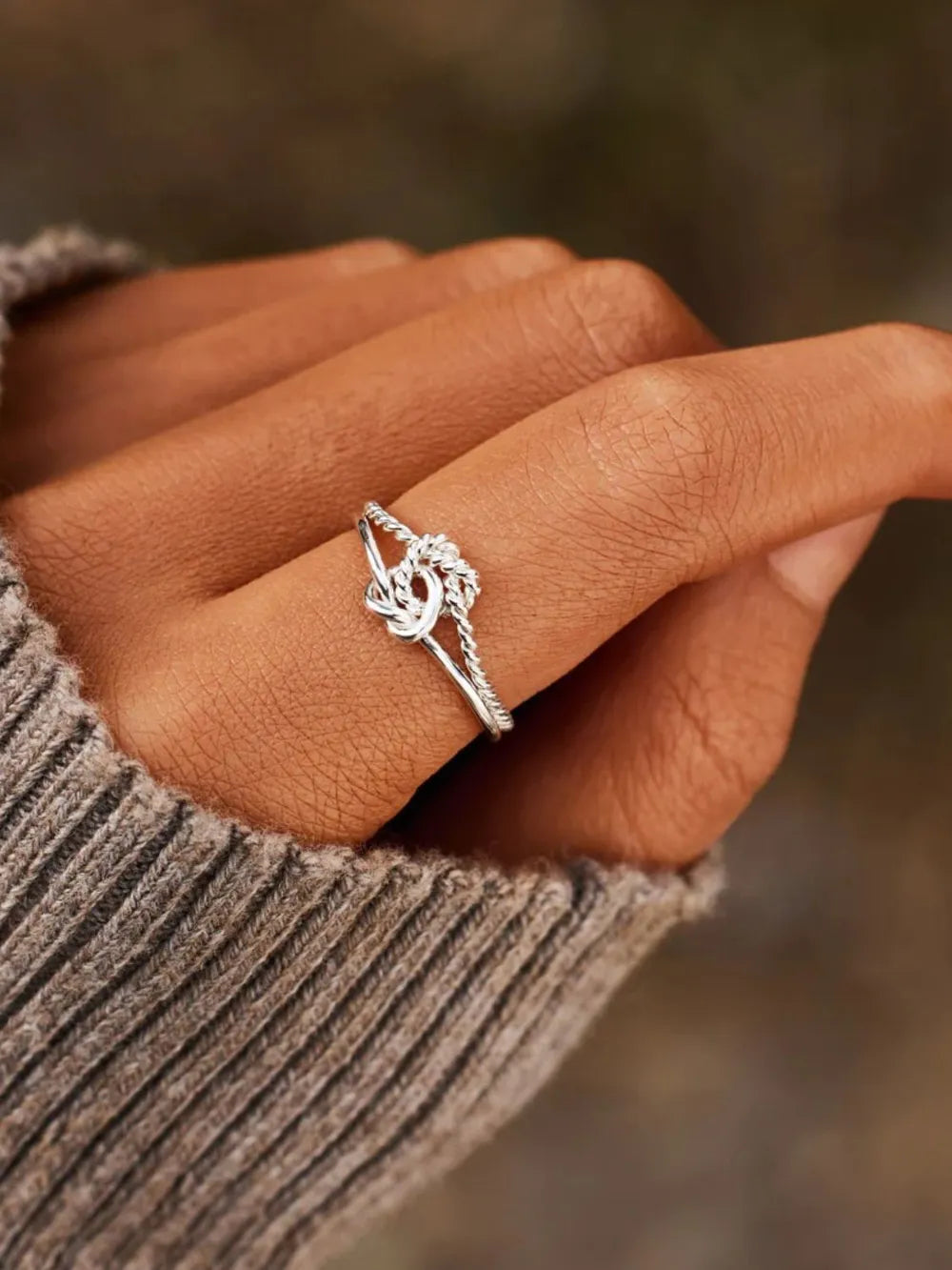 Silver rope knot ring made of 925 sterling silver, adjustable for casual wear.