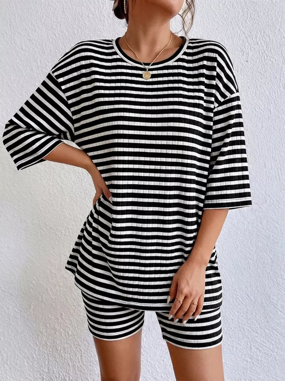 Chic striped two-piece set with elbow sleeve top and shorts in black stripes.
