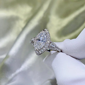 White gold marquise halo moissanite engagement ring with baguette side stones.