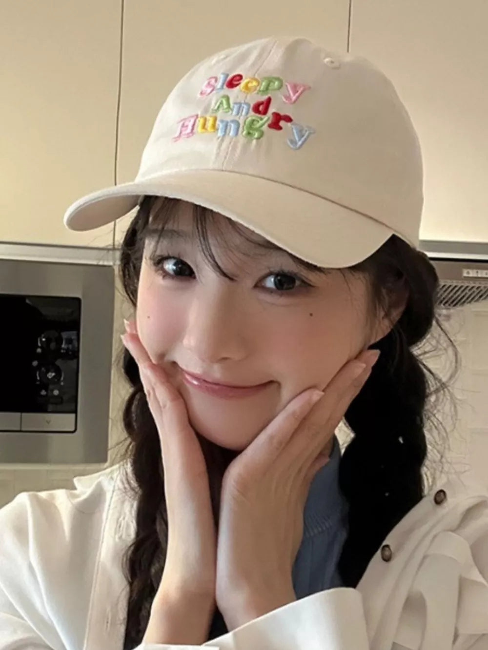 Beige baseball cap with colorful "Sleepy And Hungry" embroidery