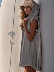 Sleeveless gray hooded romper with raw edges and a zipper front detail.