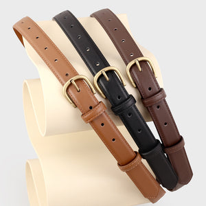 Sleek cowhide leather belts in coffee brown, black, and brown with antique brass buckles.