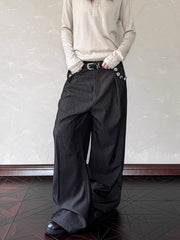 Men's black wide leg sweatpants with decorative buttons and a belt.