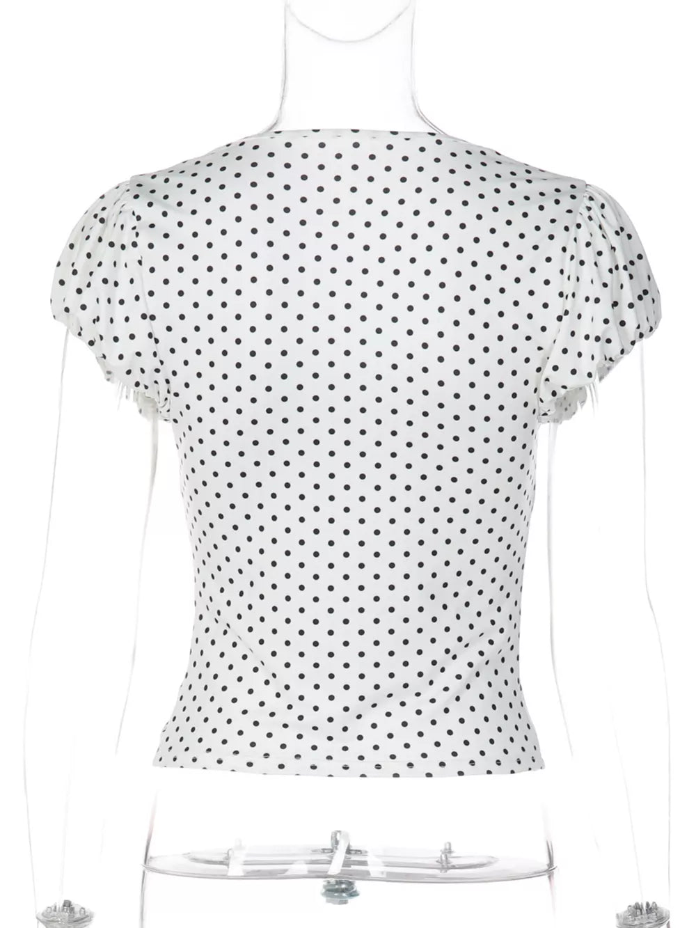 White polka dot ruched t-shirt with short sleeves and a V-neckline.