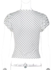 White polka dot ruched t-shirt with short sleeves and a V-neckline.