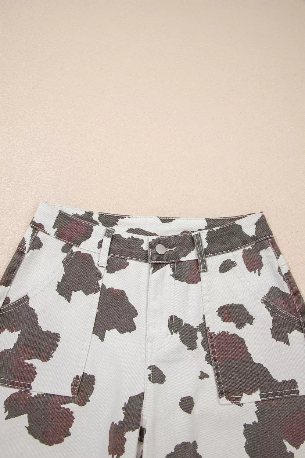 Cow print utility jeans in cotton blend with cargo pockets.