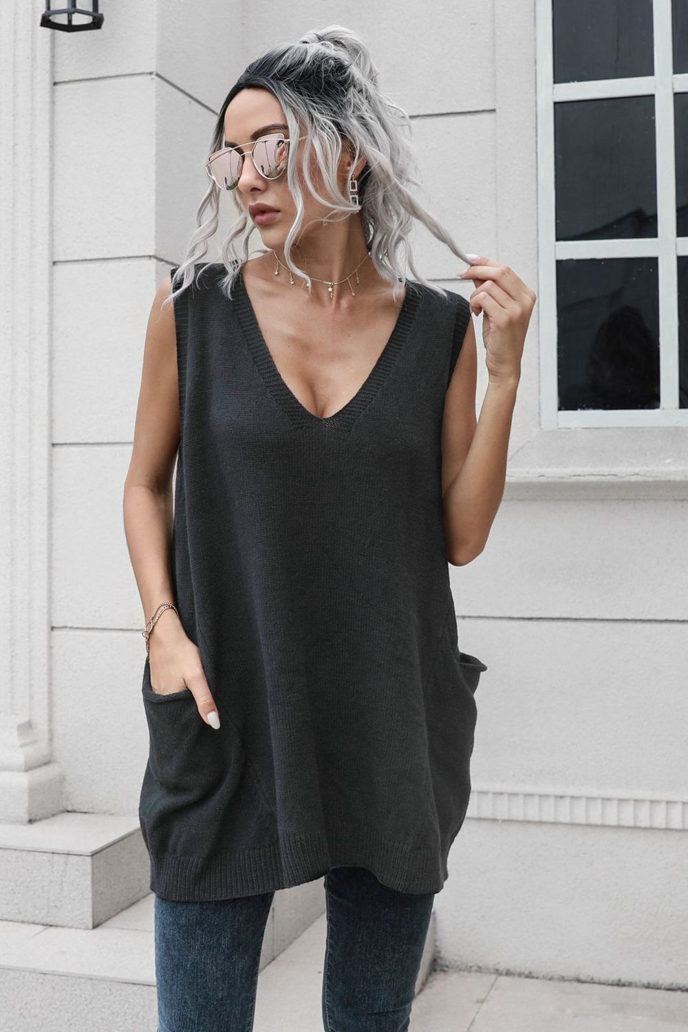 Black oversized knit vest with V-neck and front pockets, acrylic material