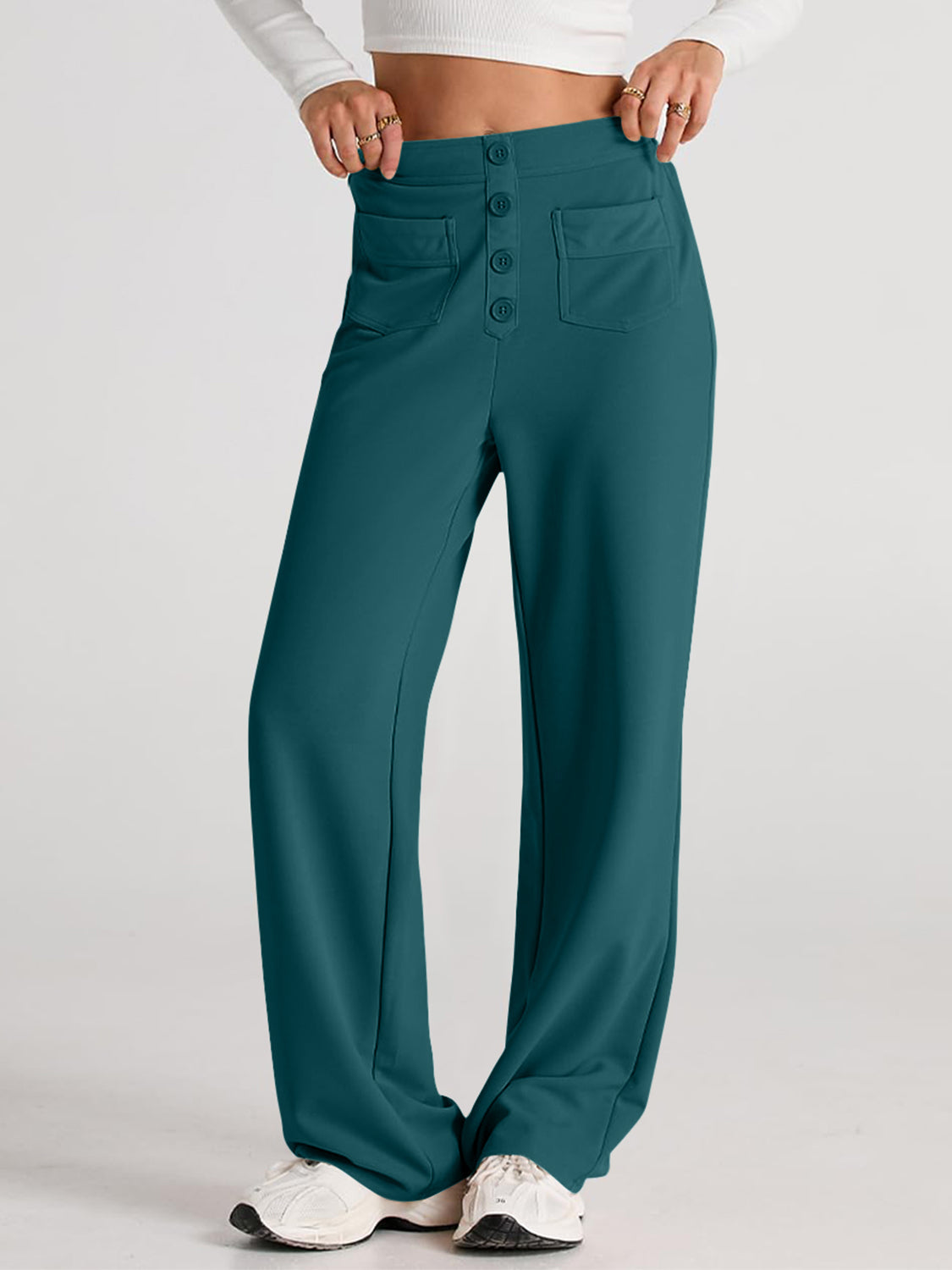 Button-front wide leg trousers in deep teal with flap pockets and a high waist.