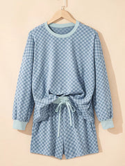 Light blue checkerboard loungewear set with crew neck pullover and drawstring shorts.