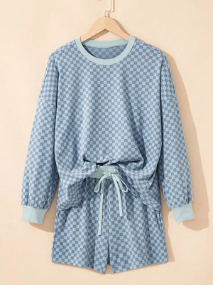 Light blue checkerboard loungewear set with crew neck pullover and drawstring shorts.