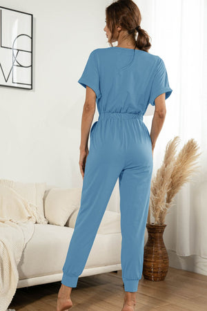 Sky blue casual jumpsuit with short sleeves, elastic waist, and cuffed ankles.