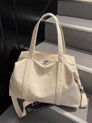 Cream white distressed vintage leather travel bag with top handles and zipper closure.