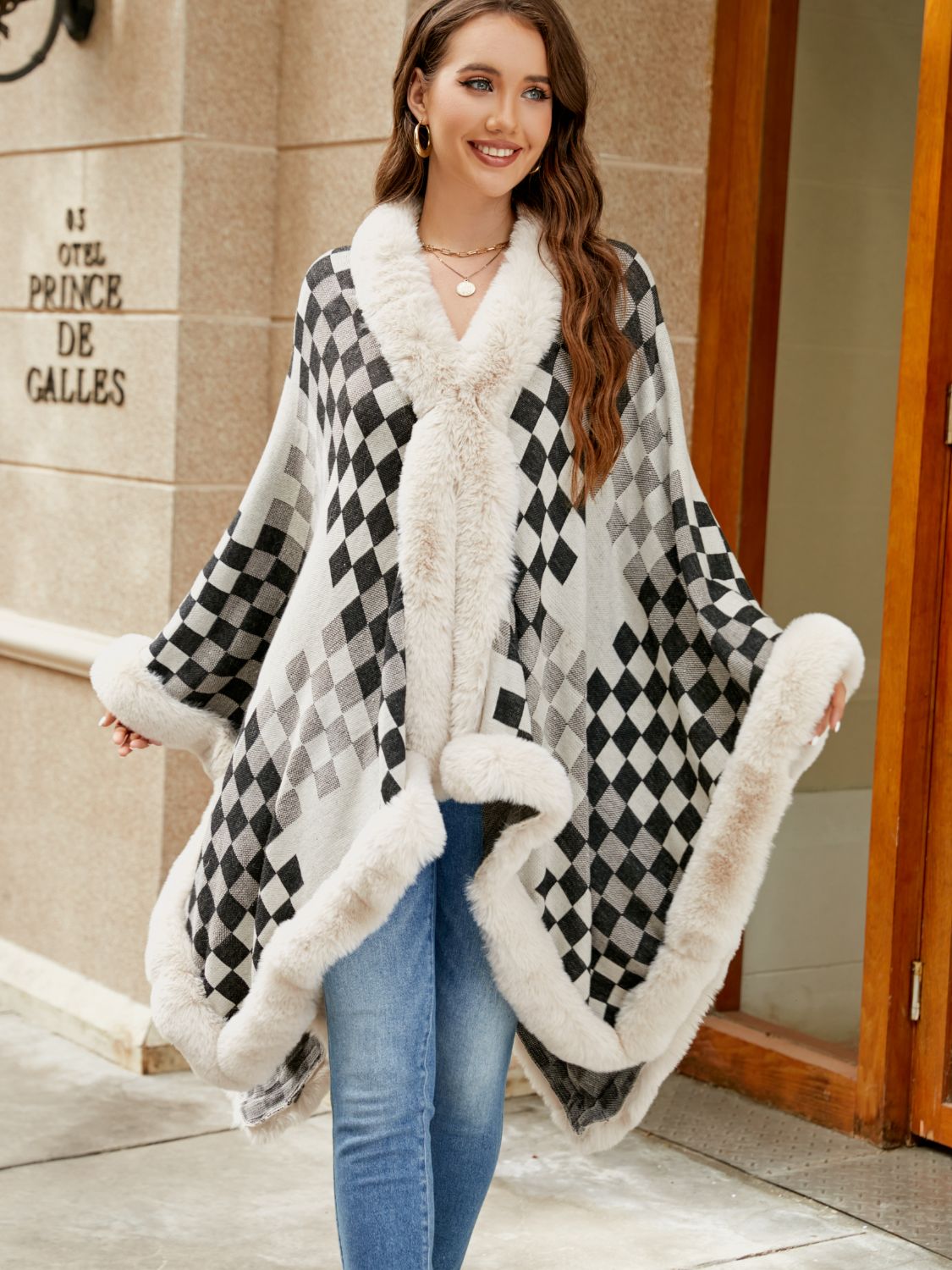Diamond checkered poncho with faux fur trim in ivory and charcoal.