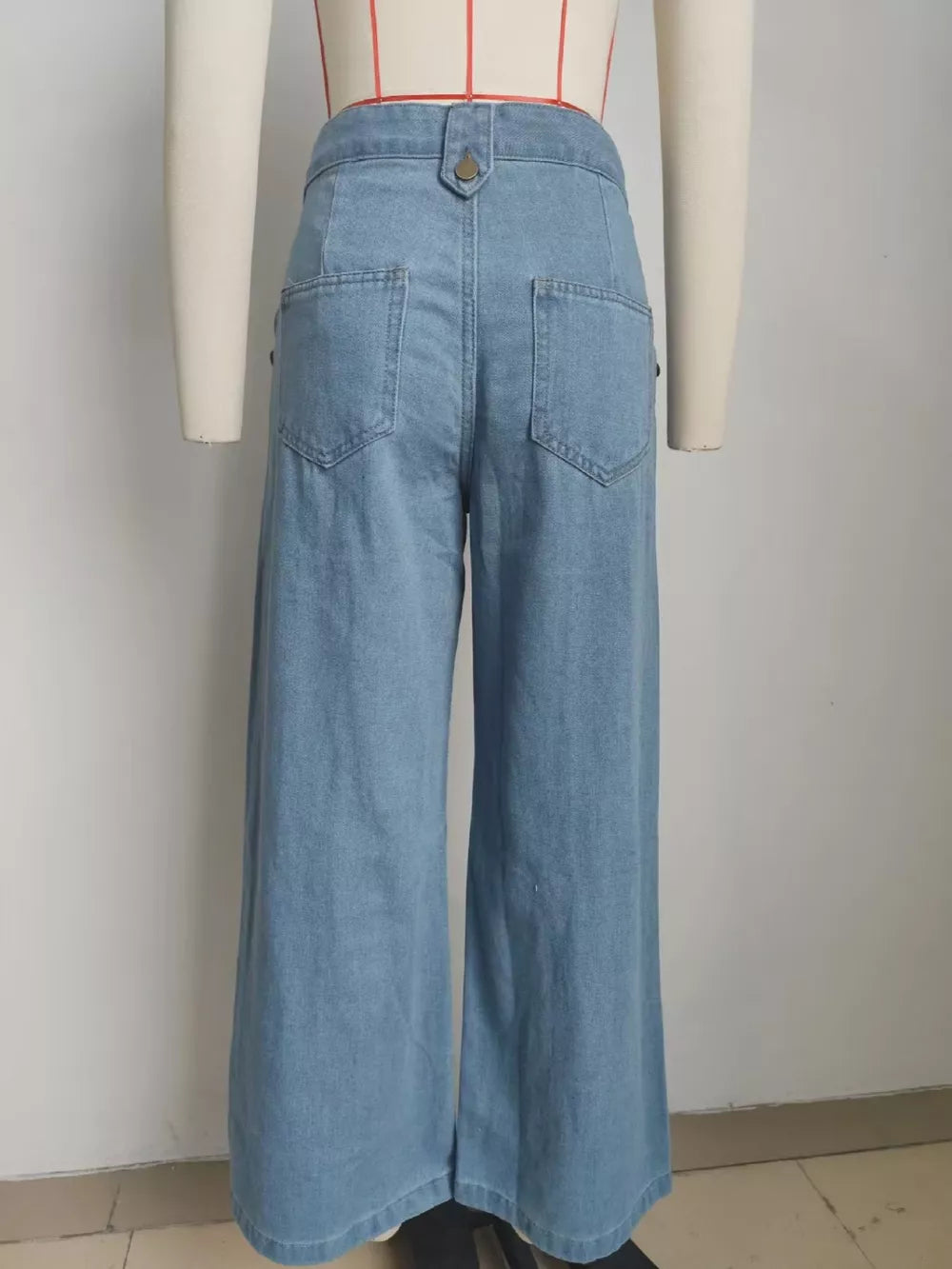 Light wash denim wide-leg pants with button closure and back pockets.