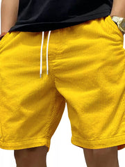 Yellow corduroy drawstring shorts with pockets and a white drawstring.