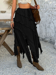 Black midi skirt with cascading ruffles and a slit hem.