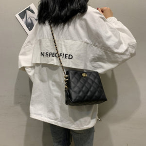 Black quilted crossbody bag with diamond pattern and chain strap