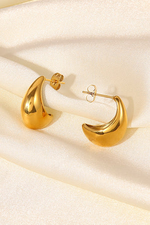 Gold sculpted crescent hoop earrings with post backs.