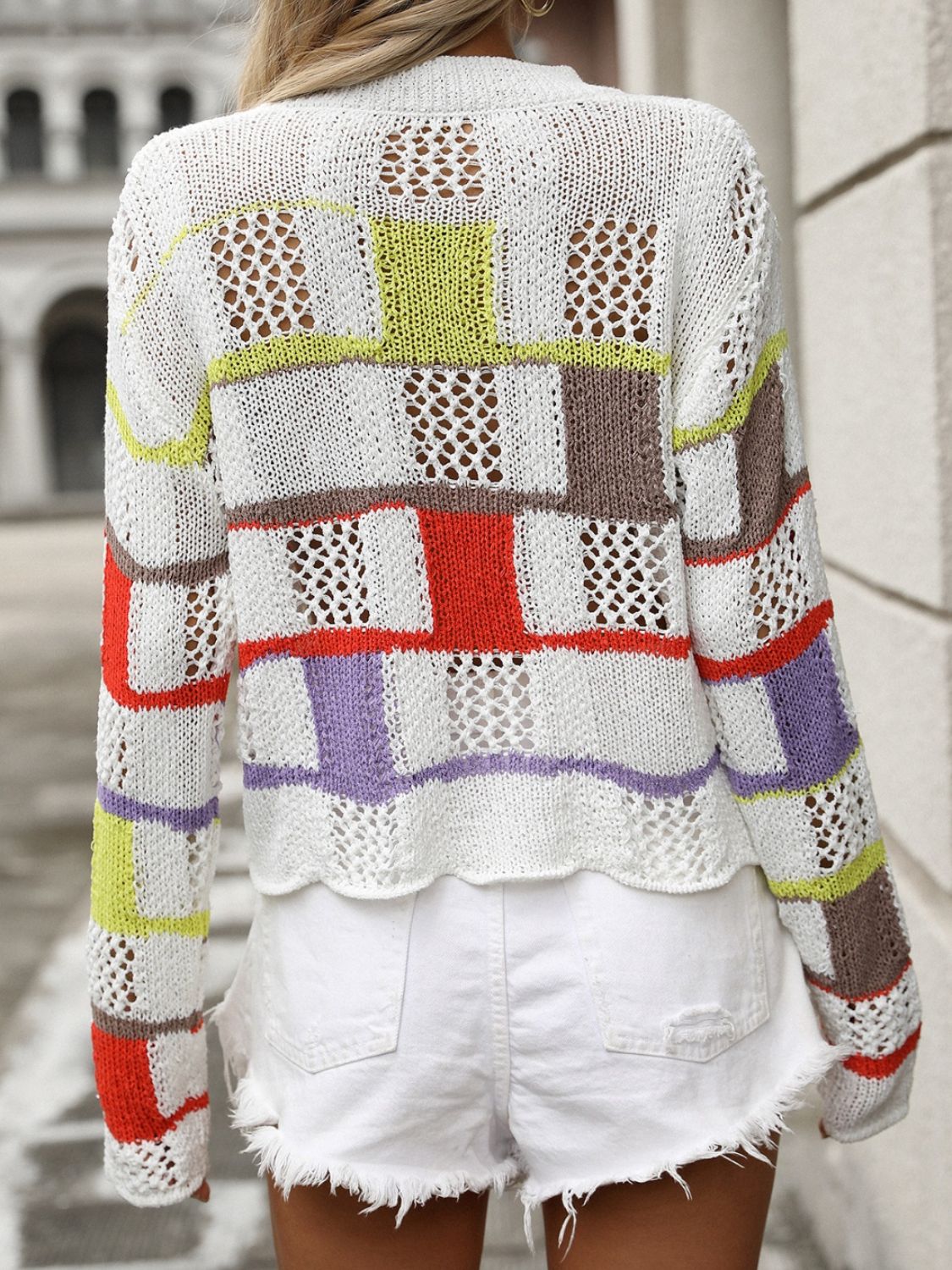 Patchwork openwork knit sweater with colorful blocks and open knit details.