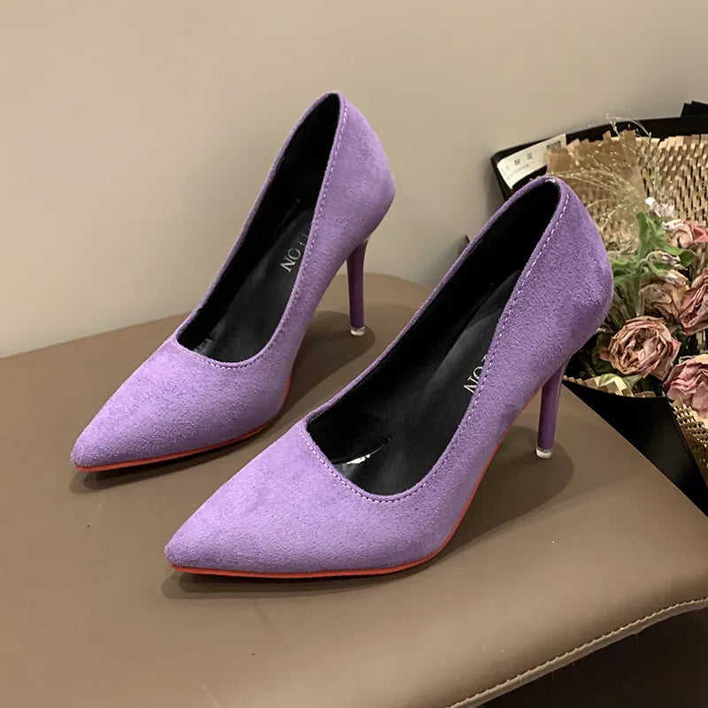 Lilac suede pointed stiletto pumps with crimson soles.
