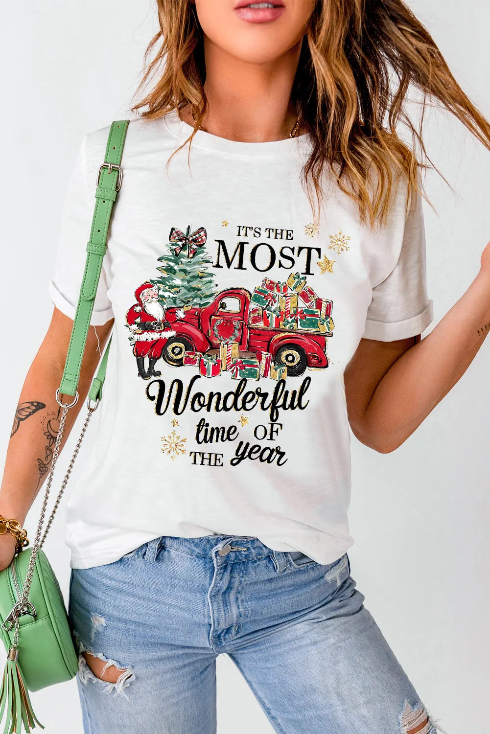 White graphic tee with Santa, Christmas tree, and red truck loaded with gifts.
