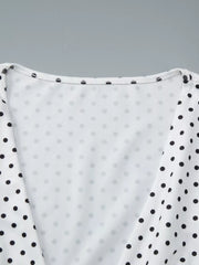 White polka dot ruched t-shirt with a v-neckline and short sleeves.