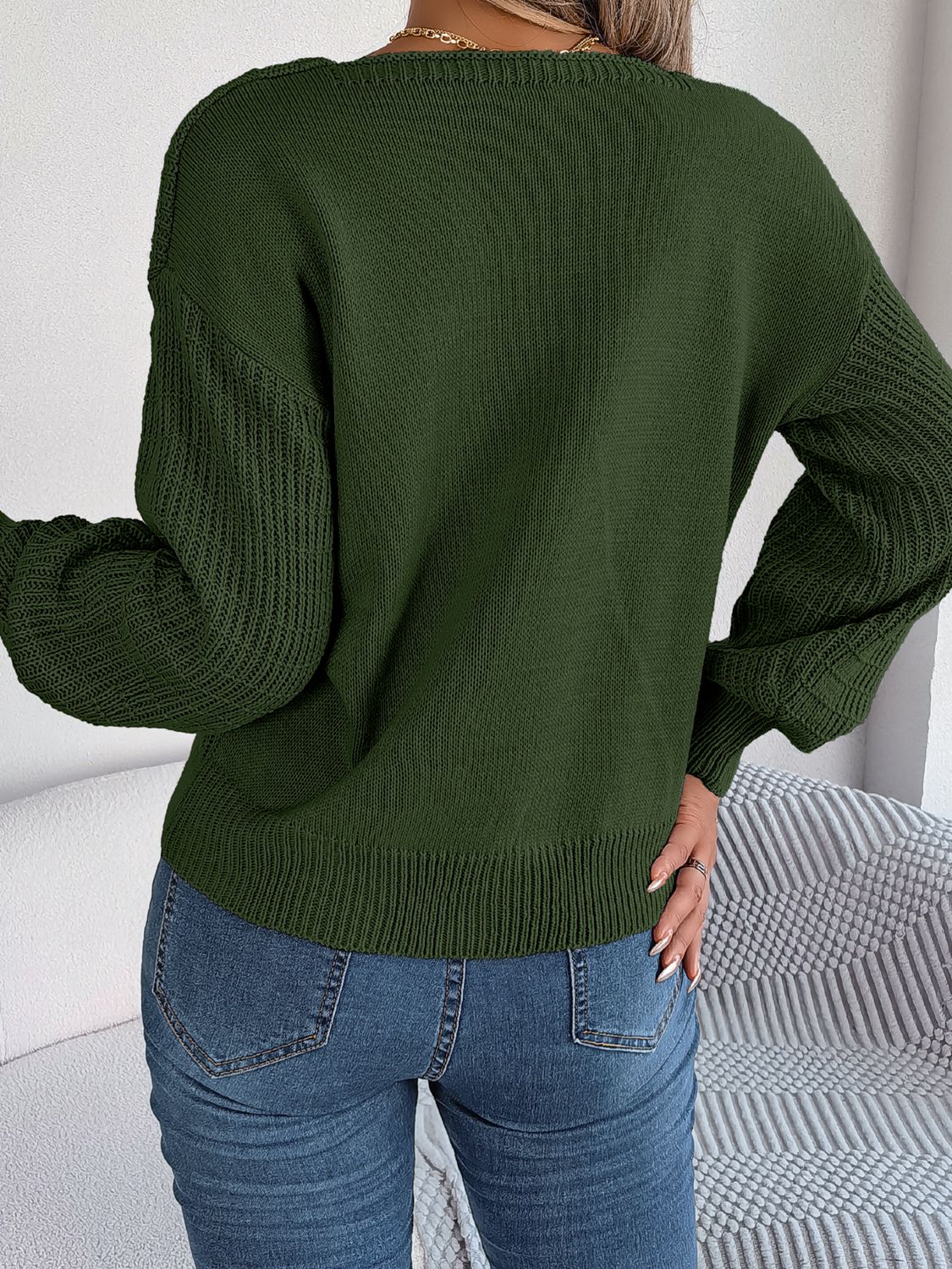 Dark green acrylic sweater with square neckline and textured sleeves.