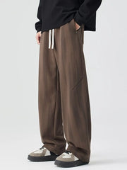 Brown jogger pants with white drawstring and subtle vertical stripes.