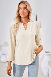 Cream textured henley shirt with V-neck and roll-tab sleeves