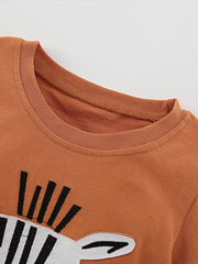 Baby tee with zebra face graphic and crew neck in rust orange.