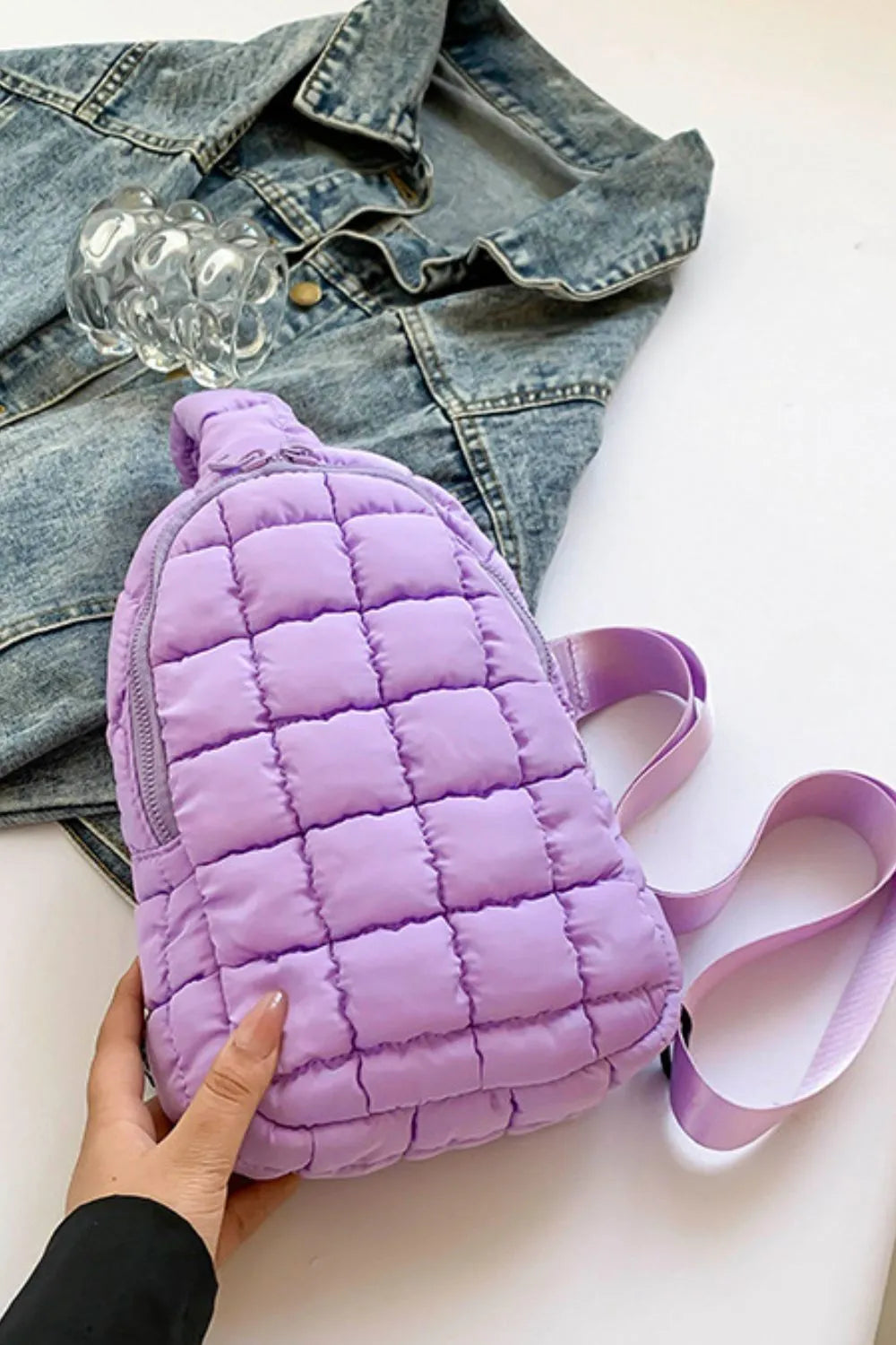 Padded sling bag in pastel blue with quilted pattern and top handle